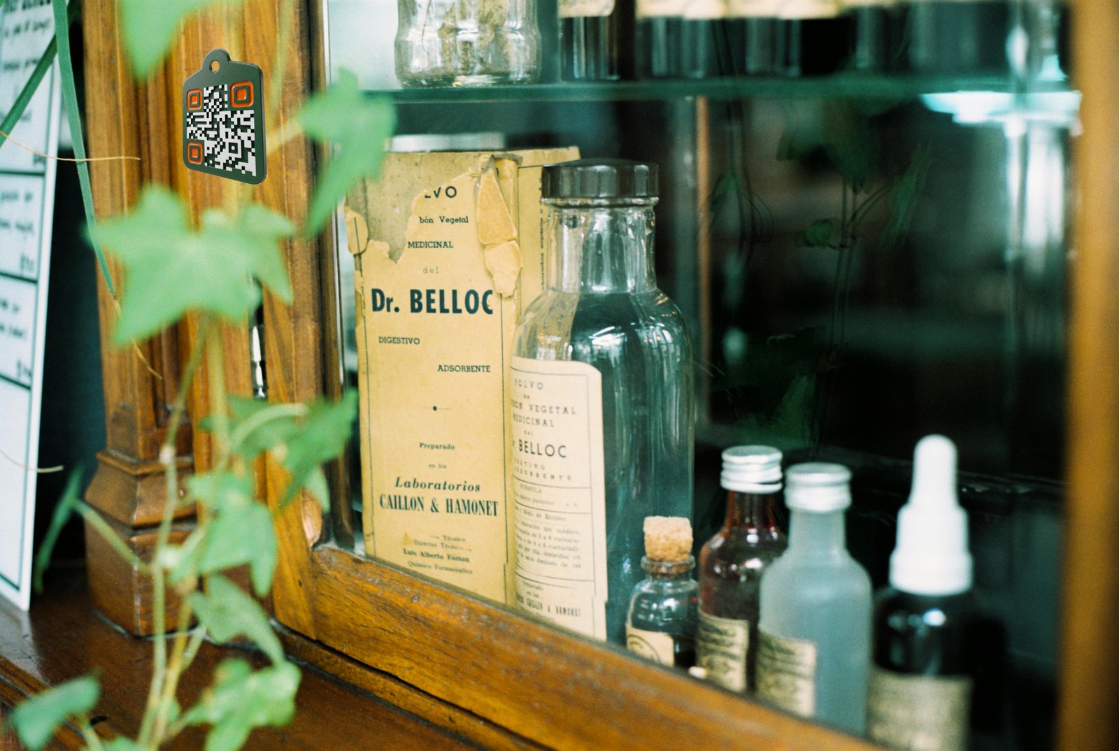 Old wooden medicine cabinet with bottles and an AgTag on the door frame